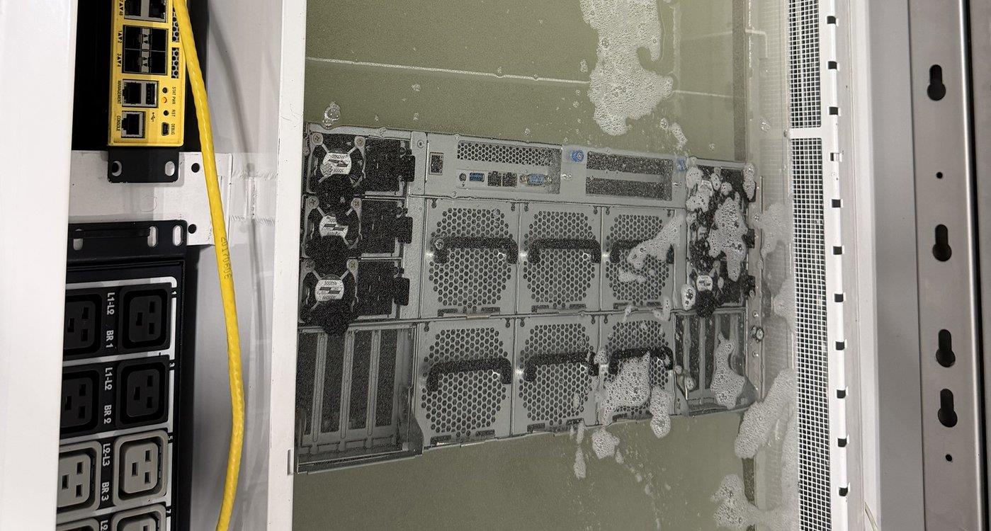 A server submerged in an immersion cooling tank